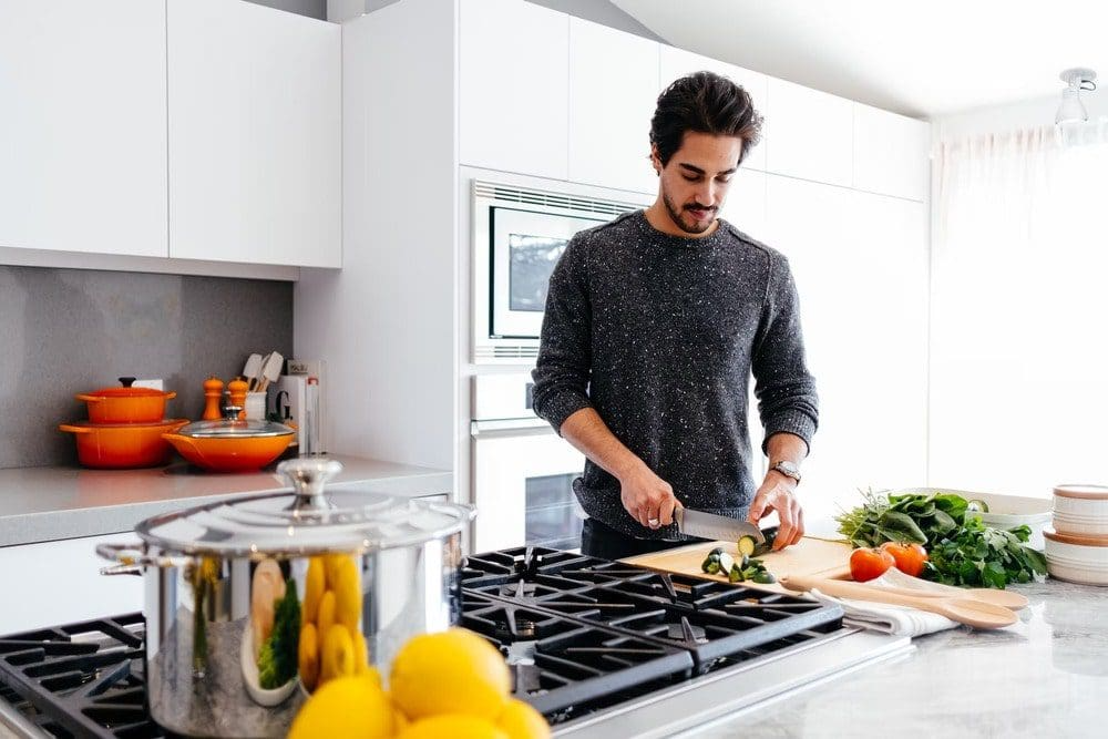 Man Enjoys Prepping Food on a Kitchen Island After a Kitchen Remodel